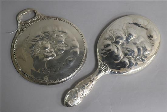 Two early 20th century repousse silver Reynolds Angels hand mirrors by William Comyns.